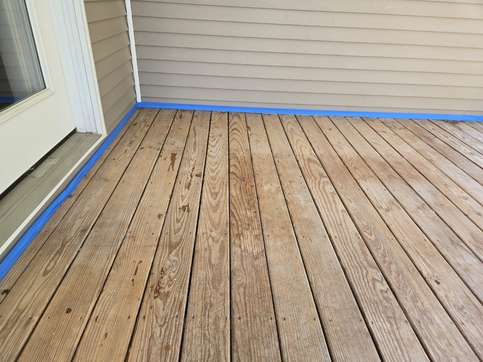 Deck boards taped and prepared for refinishing